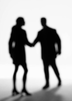 Silhouette of people shaking hands